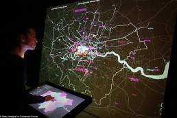 A visitor interacts with London Data Streams installation by Tekja at Big Bang data exhibition at Somerset House